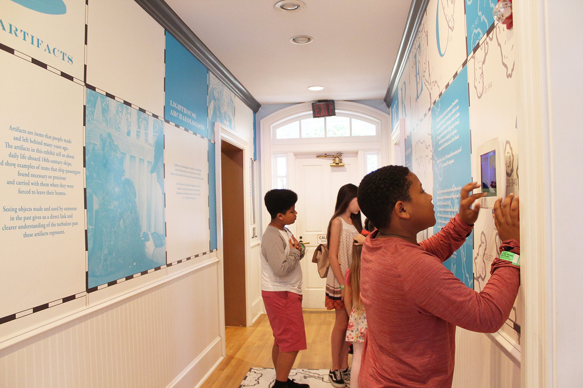 Children inside the lighthouse reading the history of the St. Augustine Lighthouse on the walls