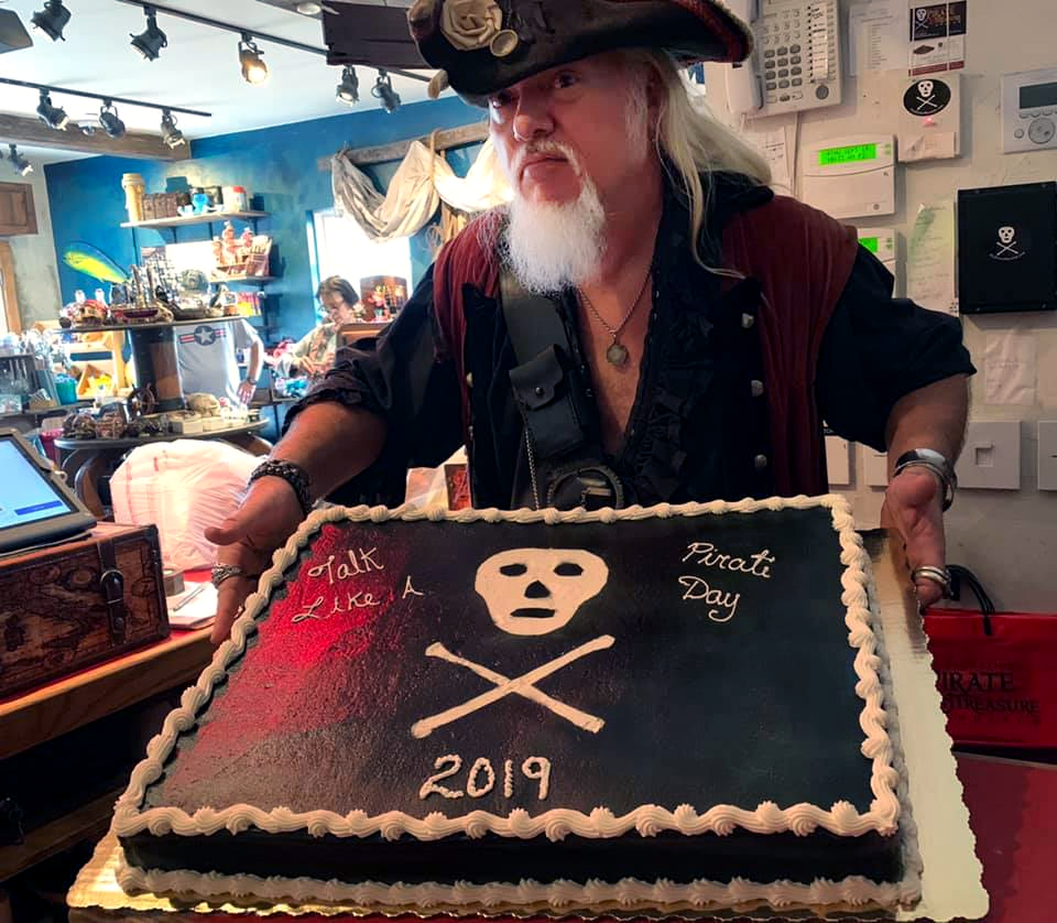 Pirate at St. Augustine Pirate Treasure Museum holding a cake stating 