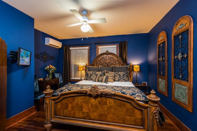 Sapphire room — Victorian bed and stained-glass window